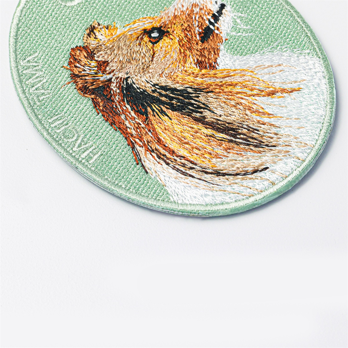 Close-up of the Rough Collie pet charm by HACHI TAMA, showing detailed embroidery
